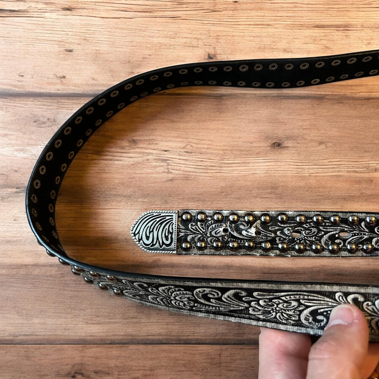 Vintage style faux leather western cowboy gothic belt in black with silver trim.