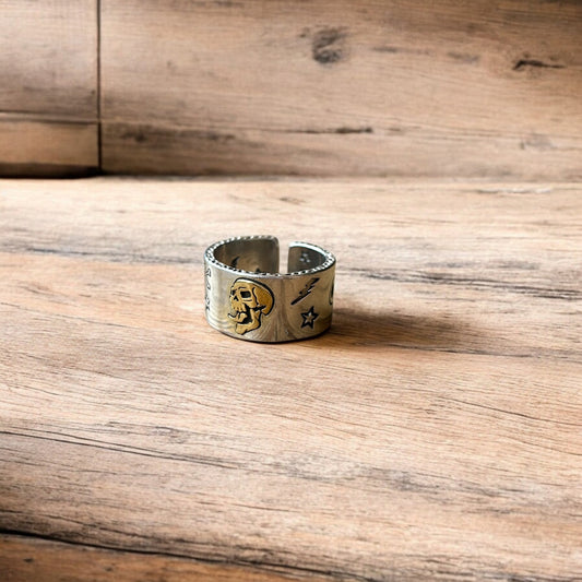 Lovely vintage style stainless steel gothic skater skull ring in silver with gold accent. One size.