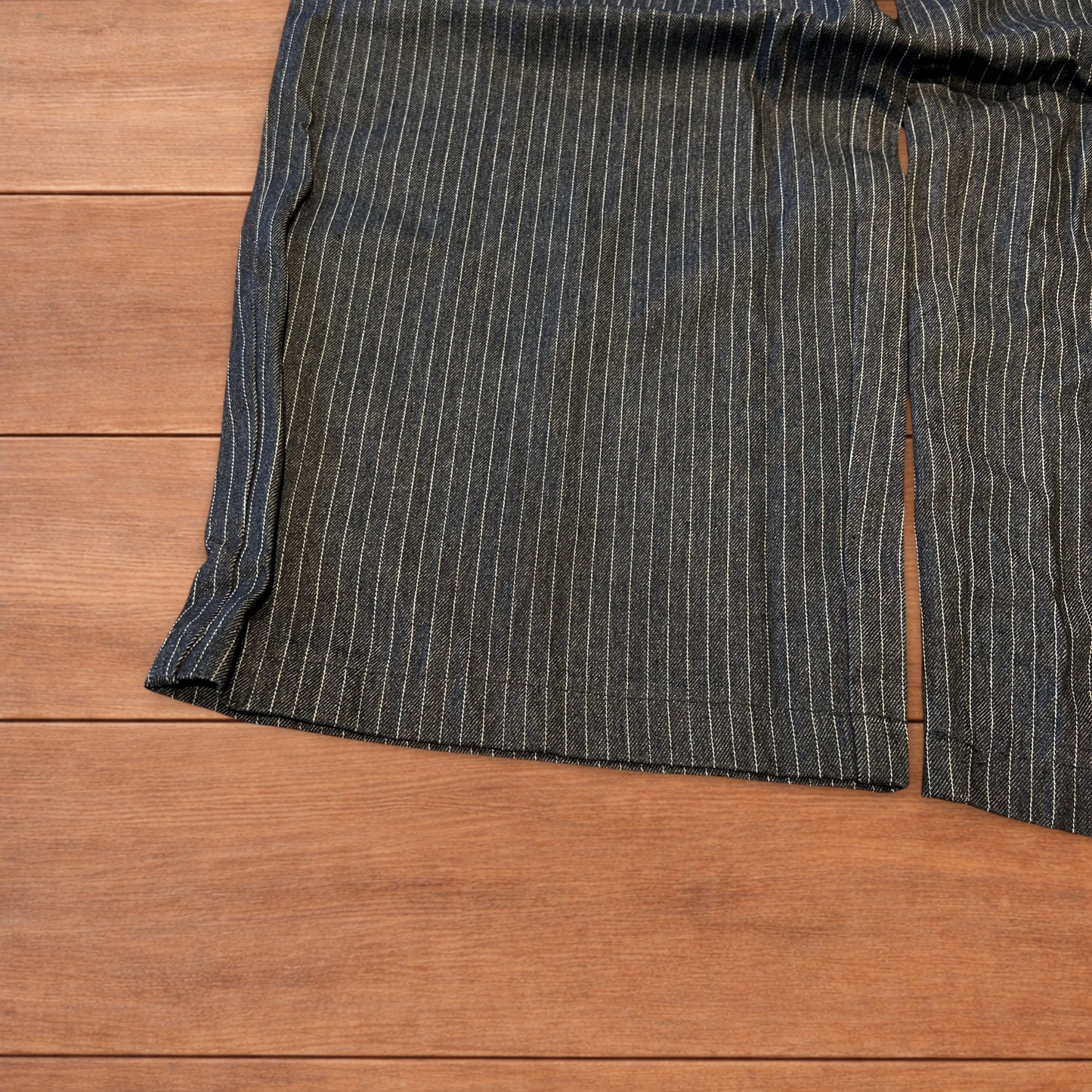 Vintage style baggy wide leg pleated twill pinstripe trousers in navy blue.
