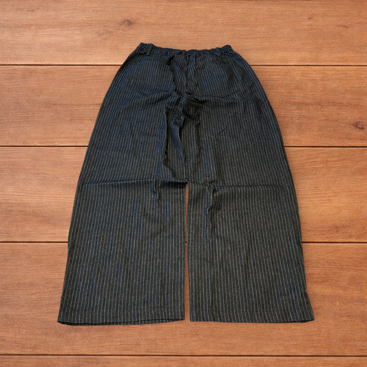 Vintage style baggy wide leg pleated twill pinstripe trousers in navy blue.
