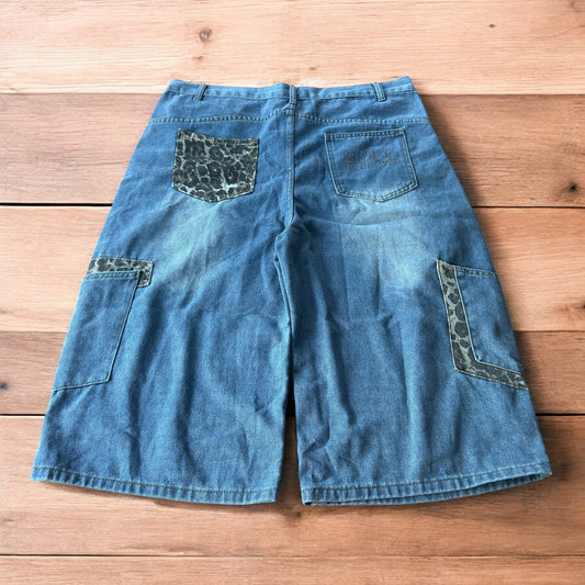 Vintage style baggy wide leg skater fit jorts shorts with leopard print in mid blue.