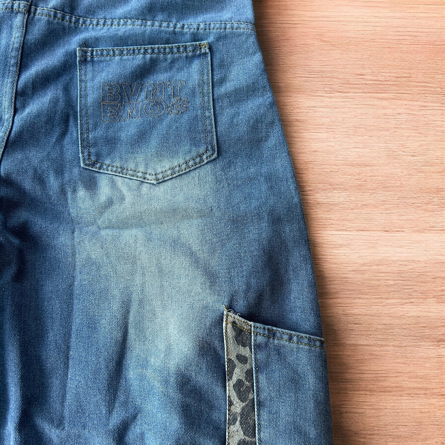 Vintage style baggy wide leg skater fit jorts shorts with leopard print in mid blue.