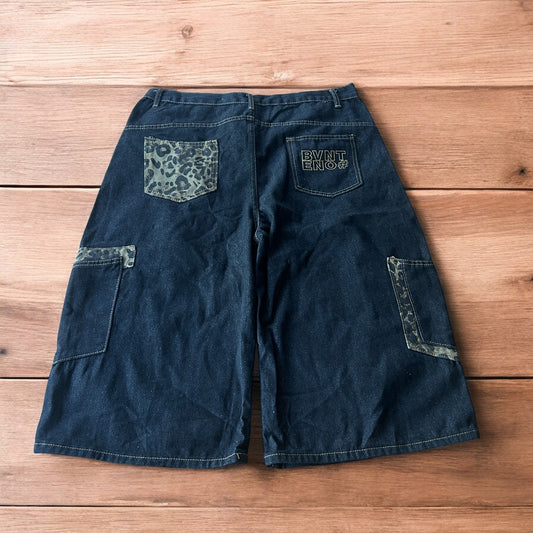 Vintage style baggy wide skater jorts shorts with leopard print in black.