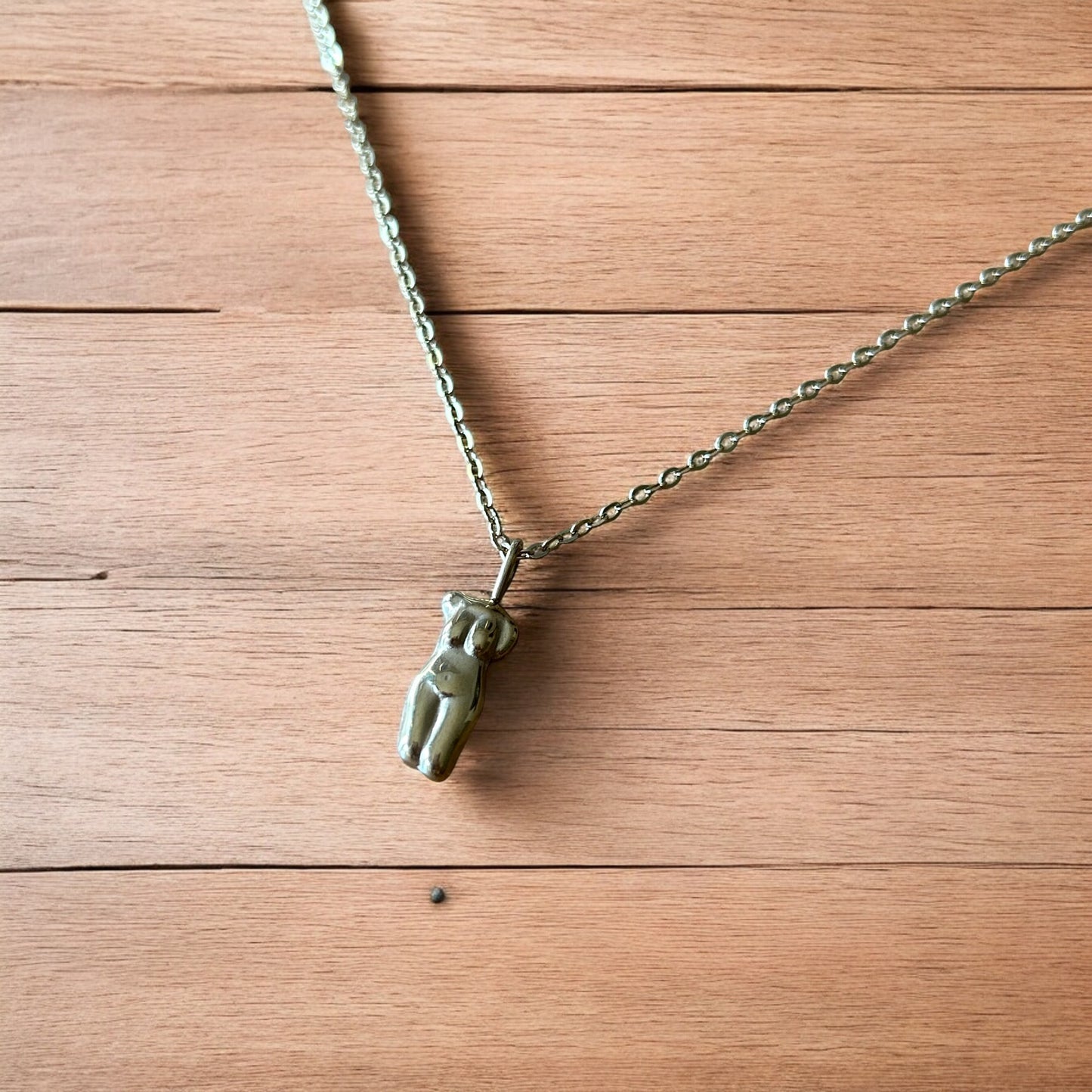 Lovely Gold stainless steel necklace of female woman figure silhouette body.