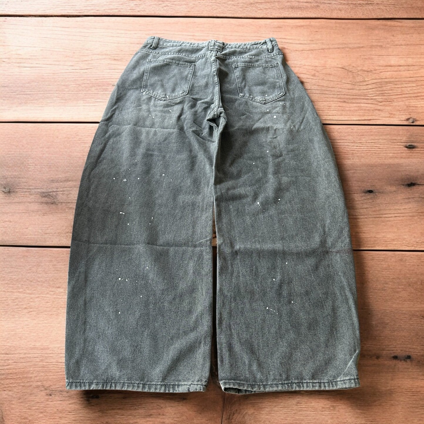 Vintage style baggy wide leg skater fit jeans in grey with paint splatters.