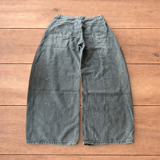 Vintage style baggy wide leg skater fit jeans in grey with paint splatters.