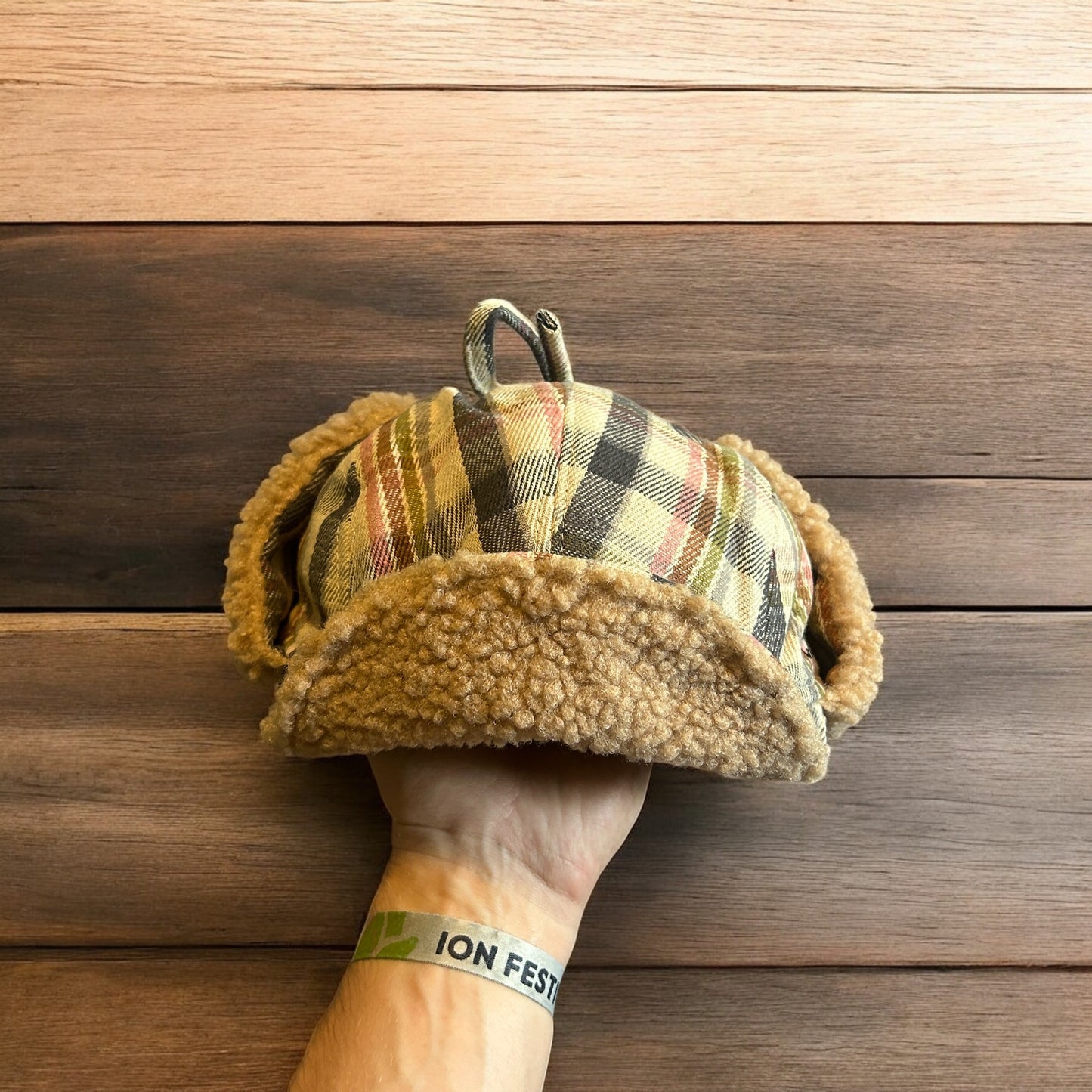 Trapper ear flap winter hat in checkered beige colour way. One size.