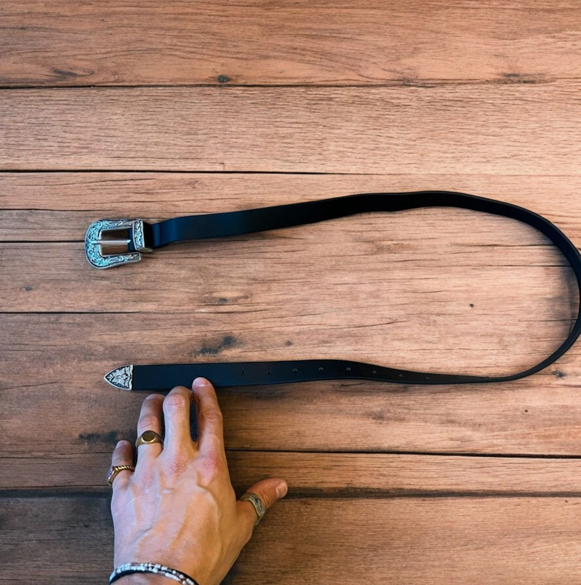 Vintage style faux leather western cowboy belt in black with silver trim. 100cm.