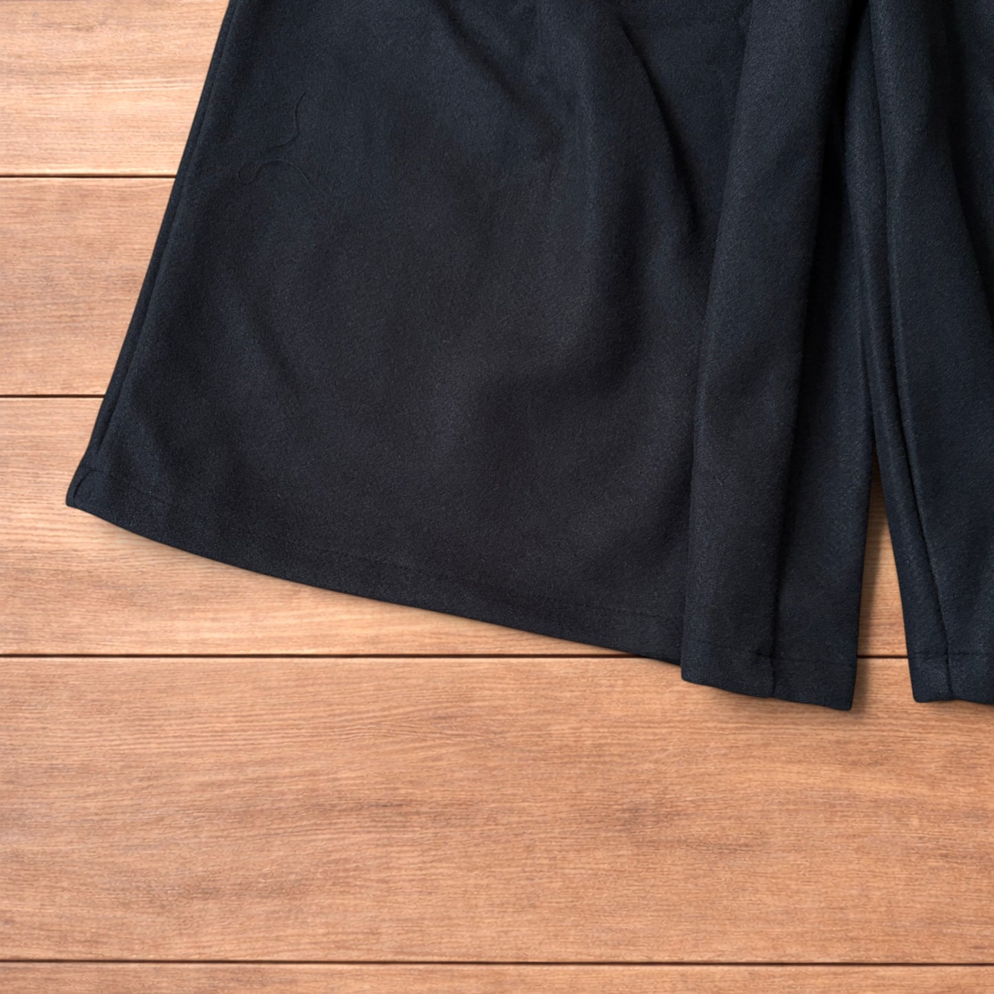 Vintage style baggy wide leg long tailored wool shorts in black.