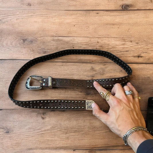 Vintage style faux leather western cowboy gothic belt in brown with silver trim.