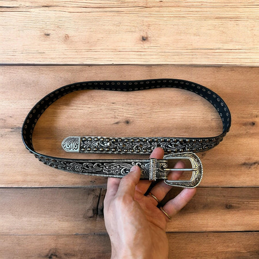Vintage style faux leather western cowboy gothic belt in black with silver trim.