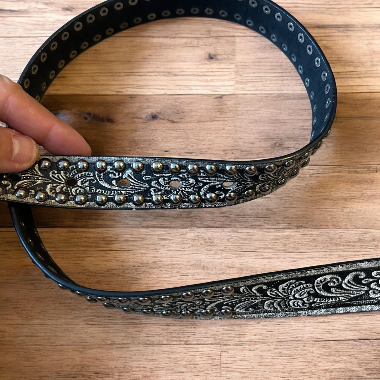 Vintage style faux leather western cowboy gothic belt in black with silver trim.