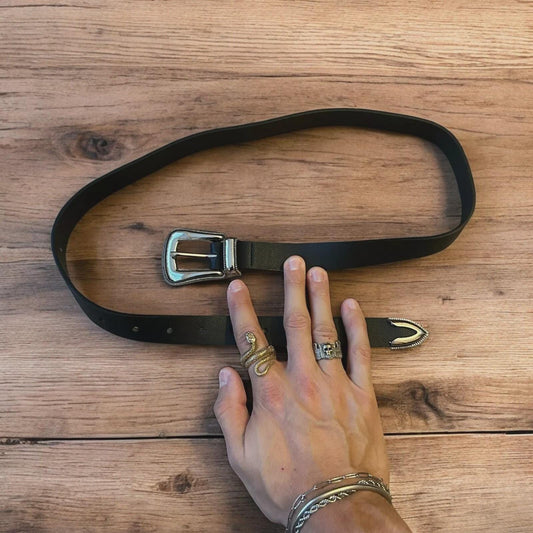 Vintage style faux leather western cowboy belt in black with silver trim. 100cm.