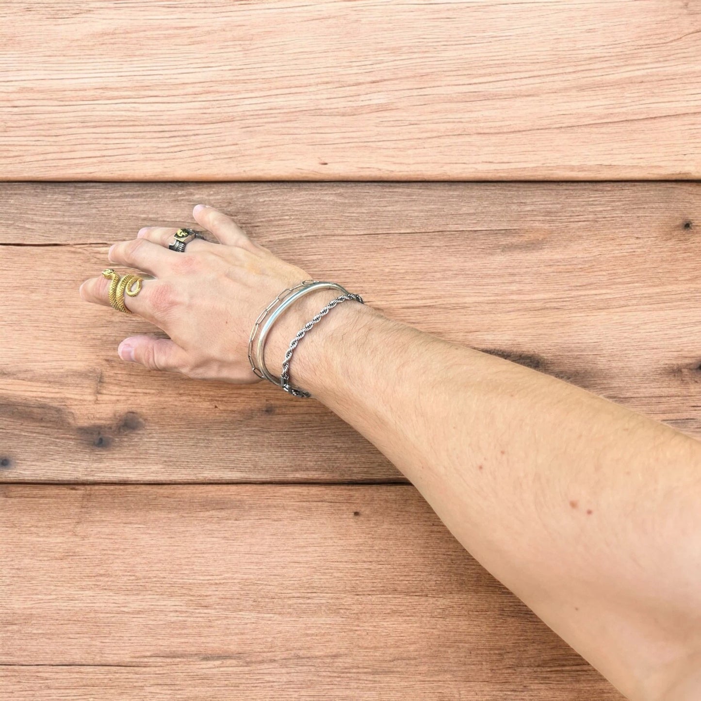 Trio of stainless steel bracelets in silver.
