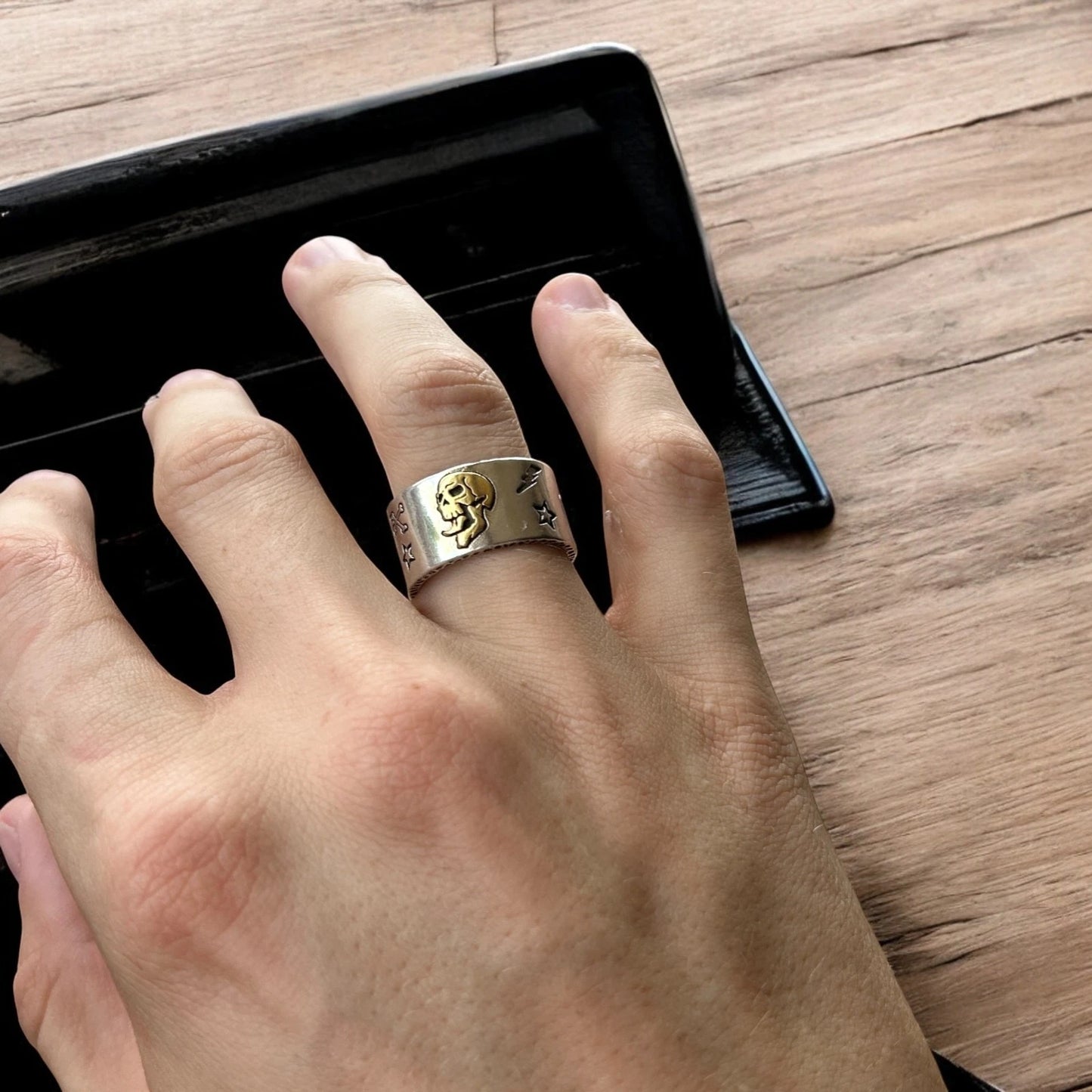 Stainless steel gothic skater skull ring in silver with gold accent. One size.