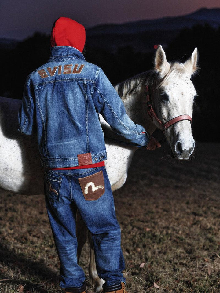Model wearing Evisu jeans featuring the brand’s signature painted seagull motif