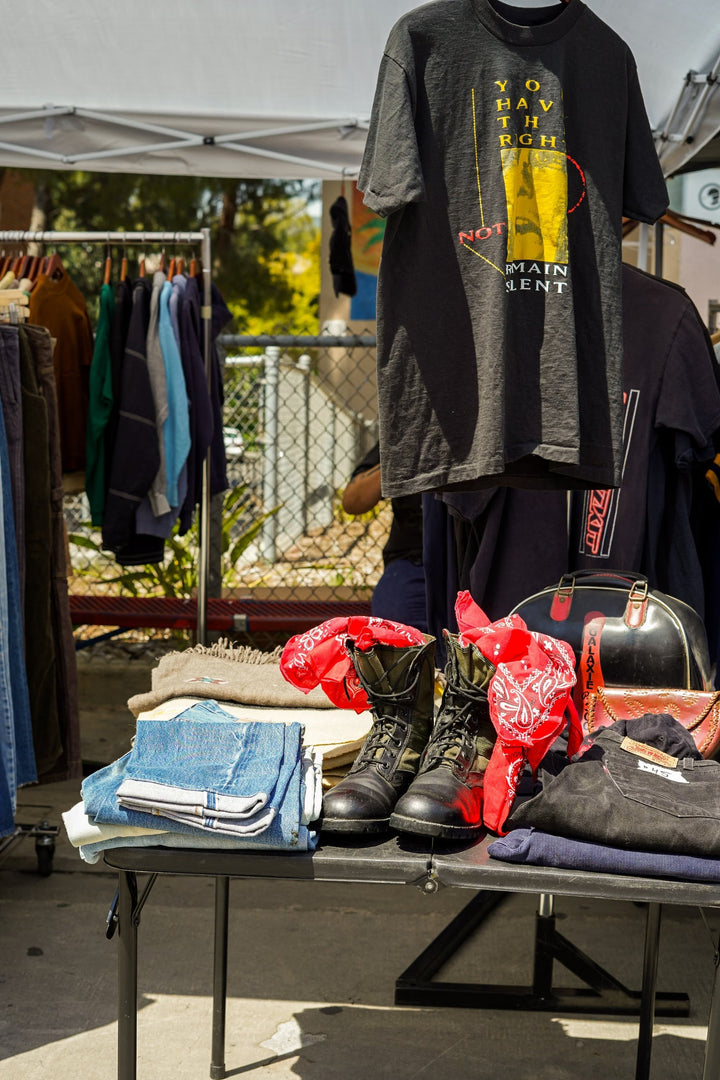 Vintage clothing and accessories displayed at an outdoor market