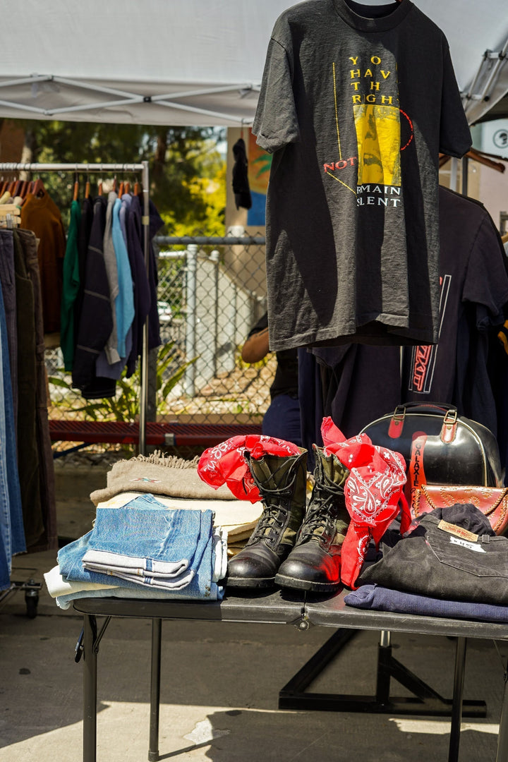 Vintage clothing and accessories displayed at an outdoor market