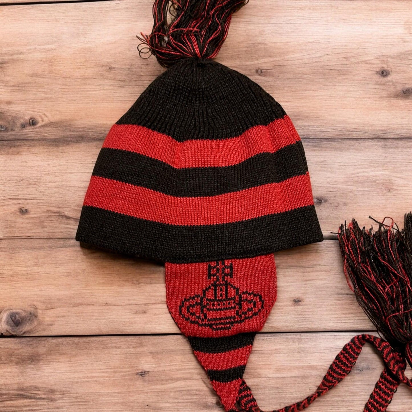 Lovely vintage style Dappy ear flap bobble hat in black/red stripes. One size.