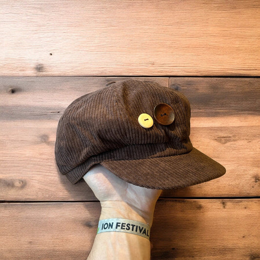 Vintage style corduroy flat cap hat with button detail in brown. One size.