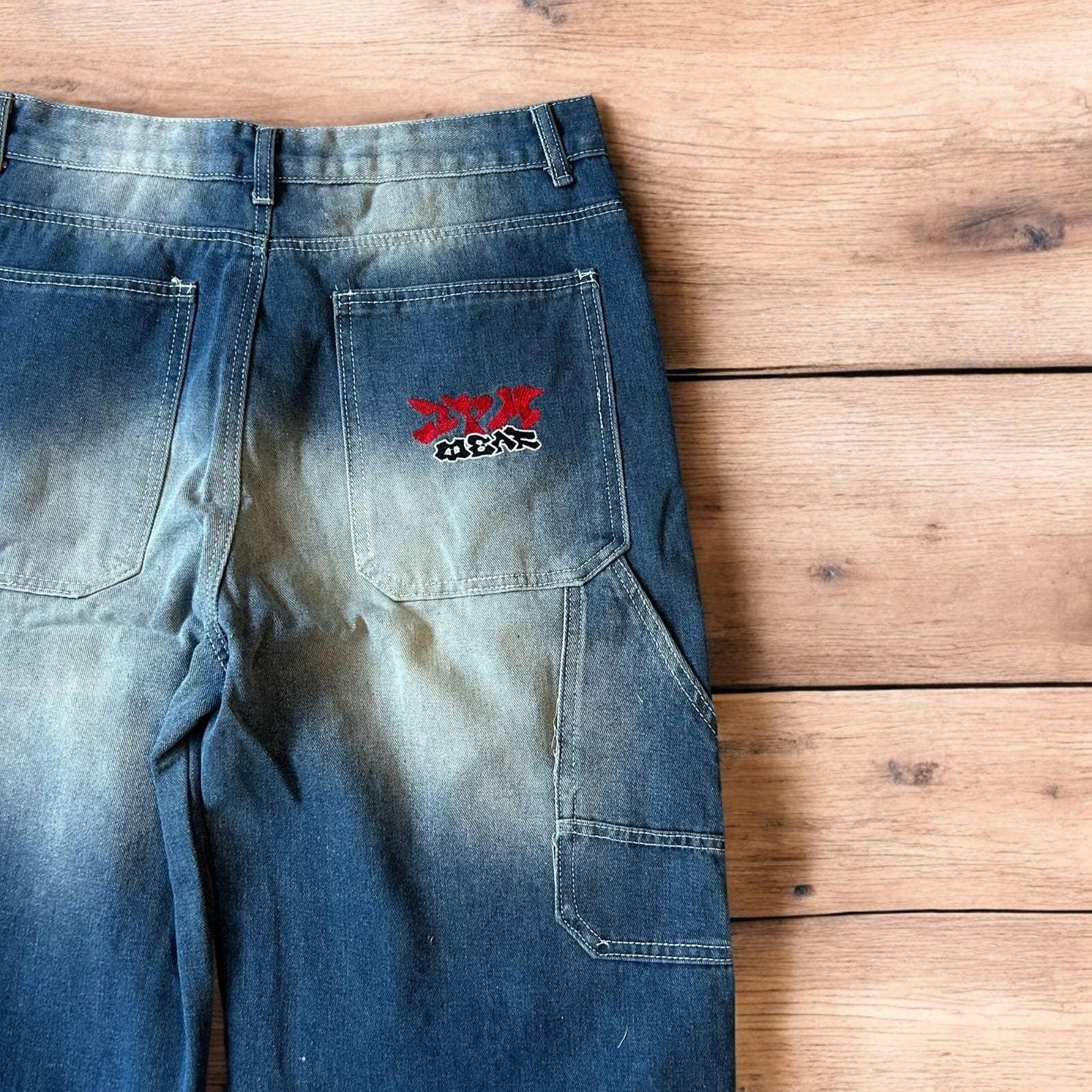 Insane baggy relaxed fit washed blue jeans with red embroidery.