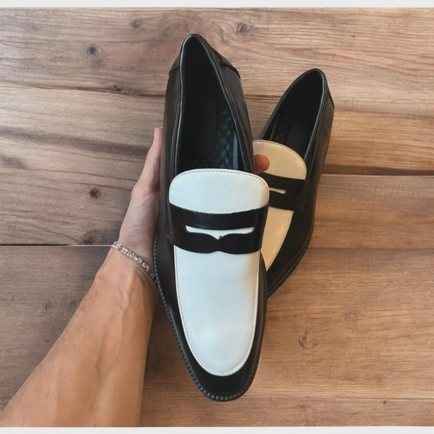 Lovely classic style penny loafers shoes in black and white design.
