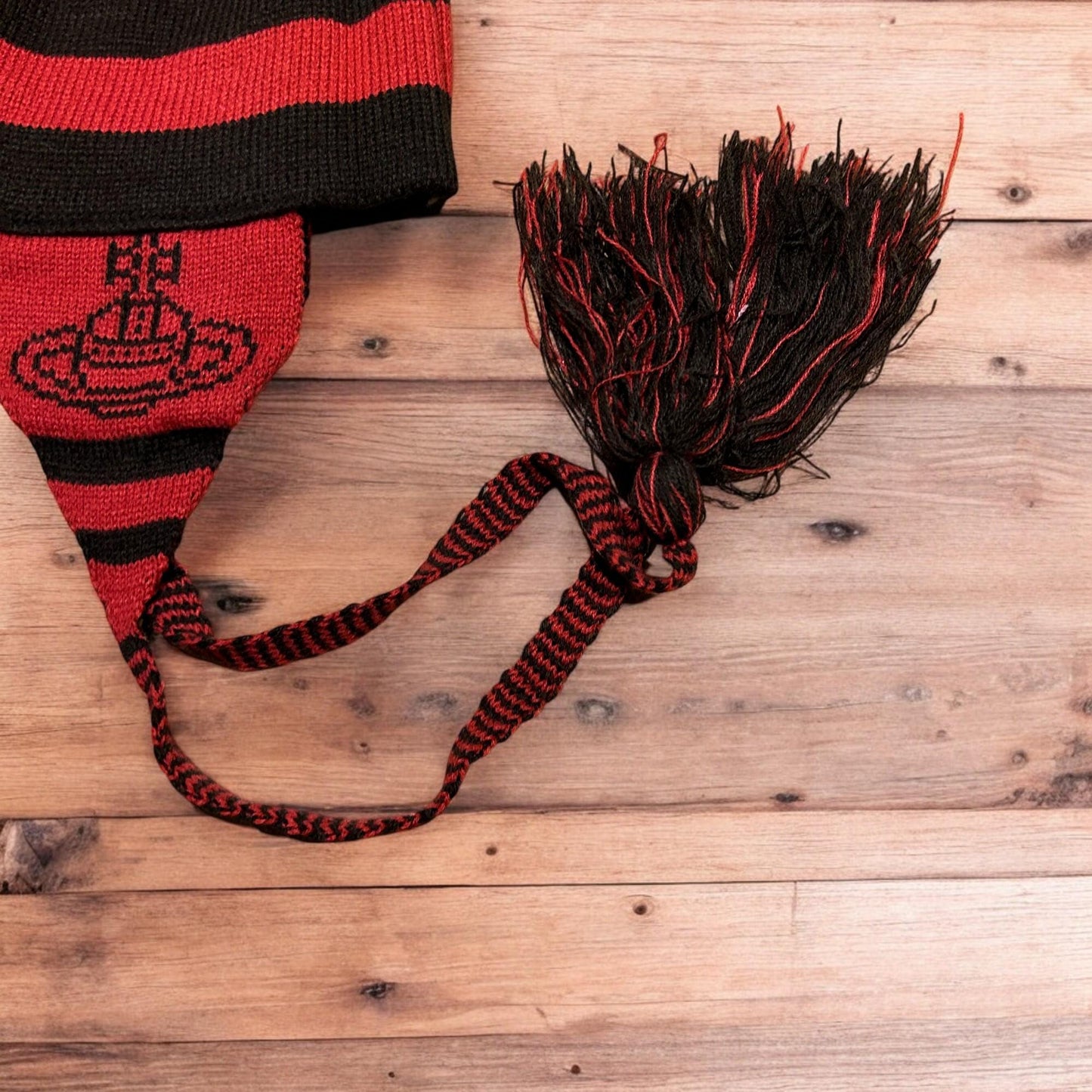 Lovely vintage style Dappy ear flap bobble hat in black/red stripes. One size.