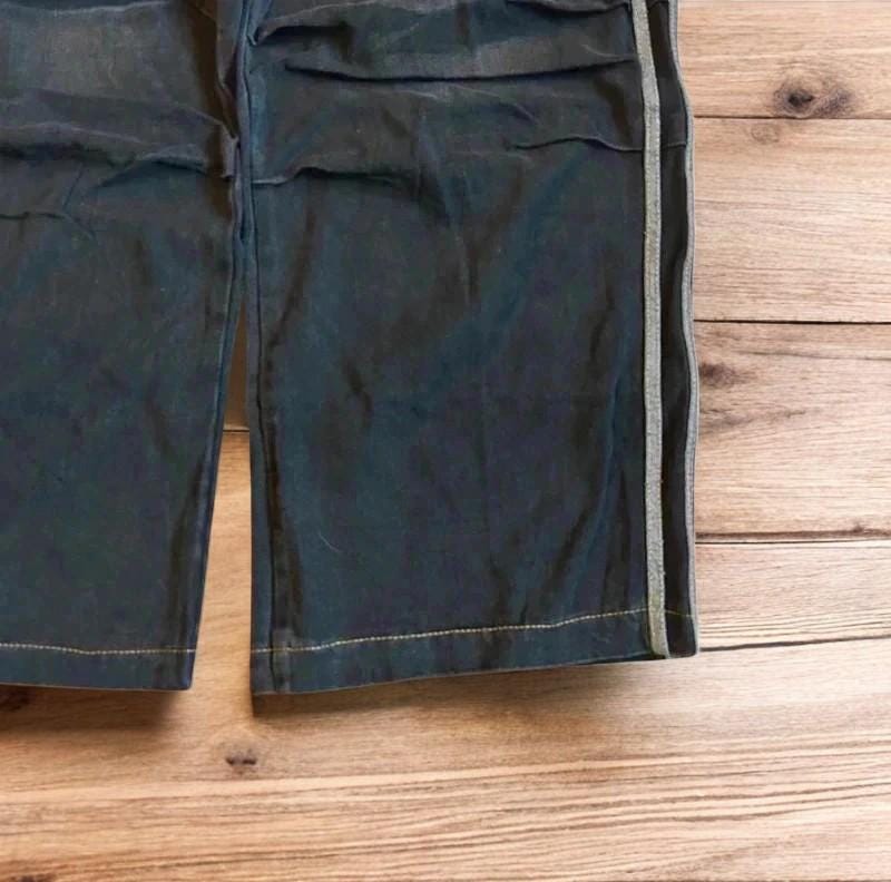 Vintage style baggy wide leg skater fit jeans with side stripes in washed black.