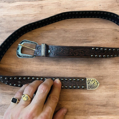Vintage style faux leather western cowboy gothic belt in brown with silver trim.