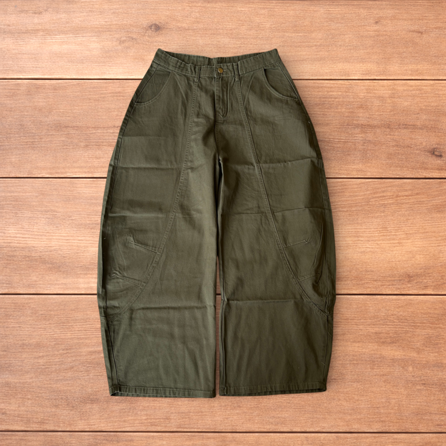 Vintage military style baggy wide leg cargo trousers in khaki green laid flat showing waistband, pockets and leg details