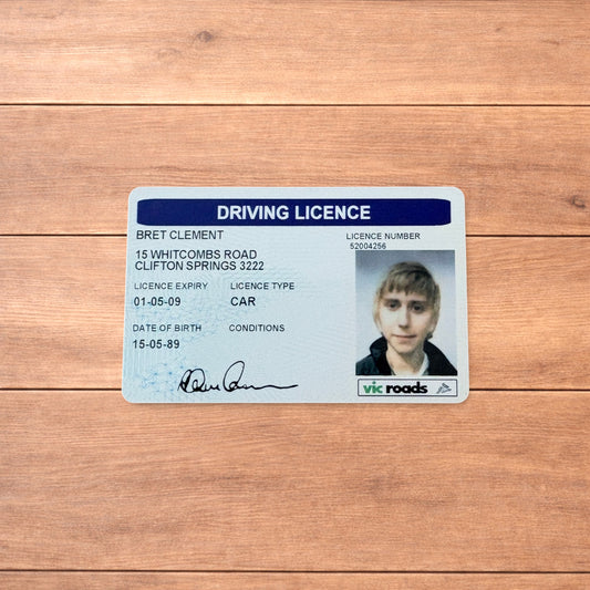 Brett Clement driving licence novelty card with blue header and photo ID, shown front and back and held in hand.