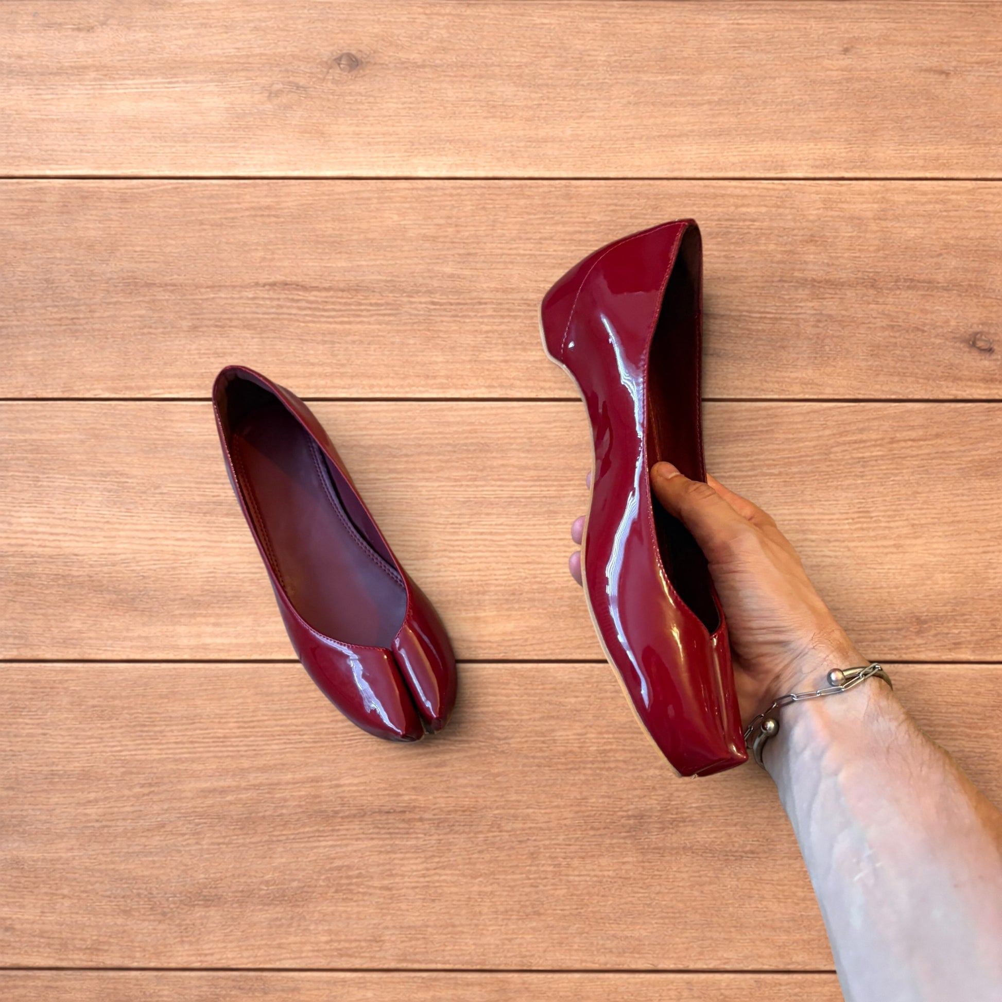 Red vintage style glossy faux leather tabi shoes with split toe and flat sole