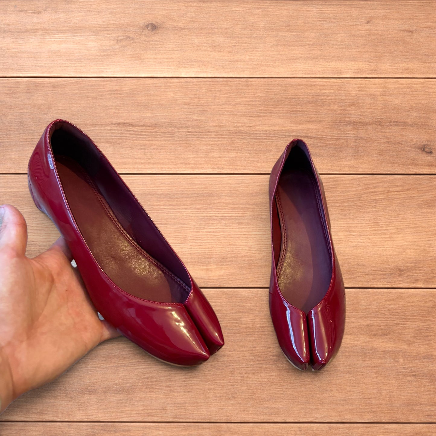 Red vintage style glossy faux leather tabi shoes with split toe and flat sole