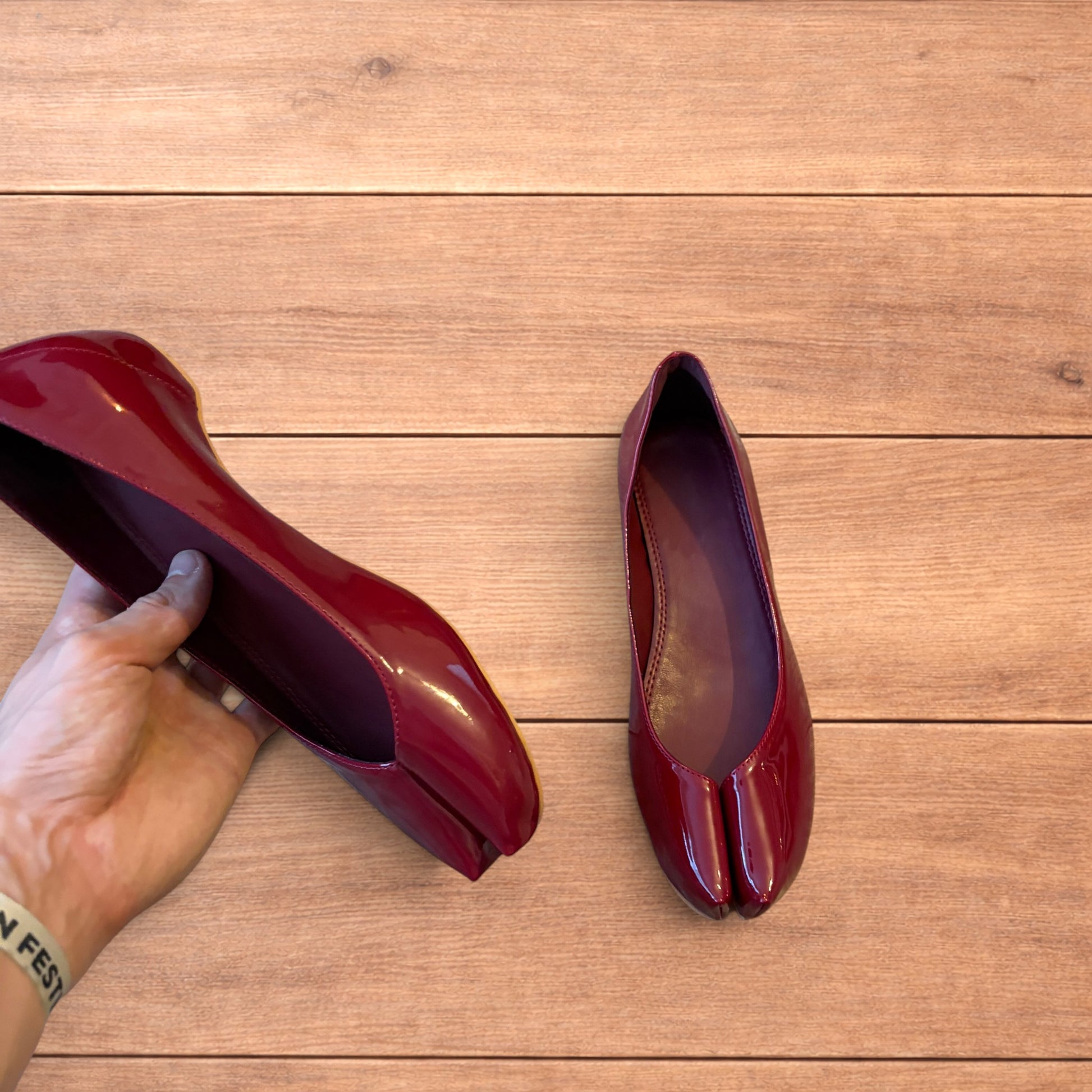 Red vintage style glossy faux leather tabi shoes with split toe and flat sole