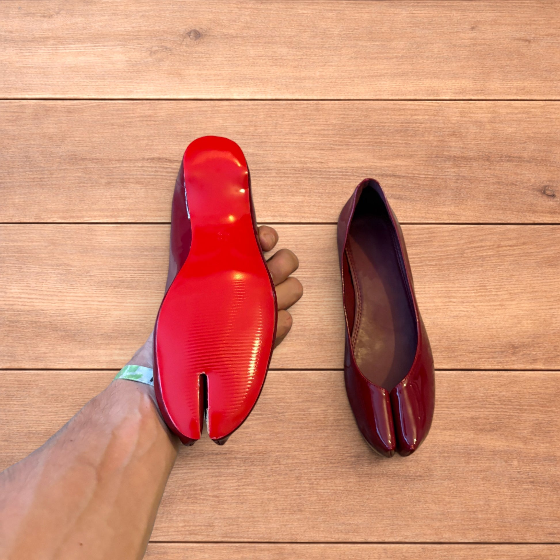 Red vintage style glossy faux leather tabi shoes with split toe and flat sole