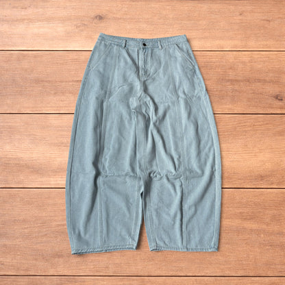 Light blue baggy wide leg vintage style denim jeans laid flat on wood surface showing front and back views