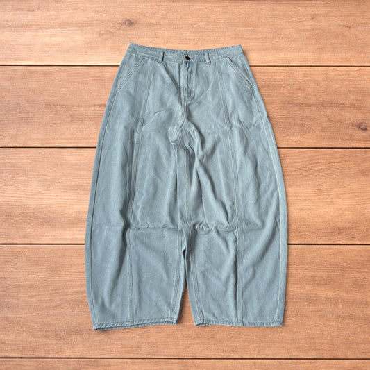 Light blue baggy wide leg vintage style denim jeans laid flat on wood surface showing front and back views