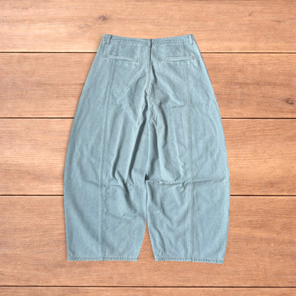 Light blue baggy wide leg vintage style denim jeans laid flat on wood surface showing front and back views