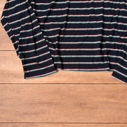 Navy navy blue striped henley long sleeve top with burgundy collar and button placket laid flat on wooden background