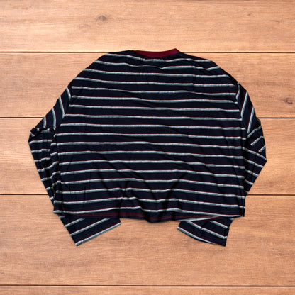 Navy navy blue striped henley long sleeve top with burgundy collar and button placket laid flat on wooden background