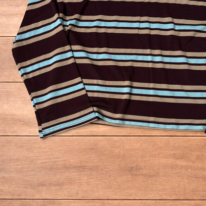 Relaxed fit long sleeve striped t-shirt in brown, blue and beige laid flat on wooden surface