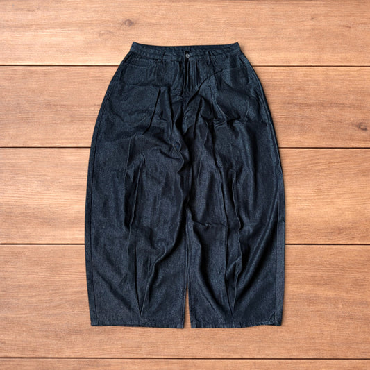 Dark grey baggy wide leg raw denim jeans laid flat showing front and back pockets and button fly