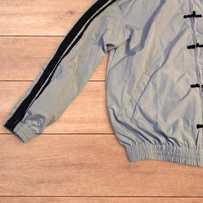 Light blue Japanese style zip up track jacket with black side stripes and toggle fasteners.