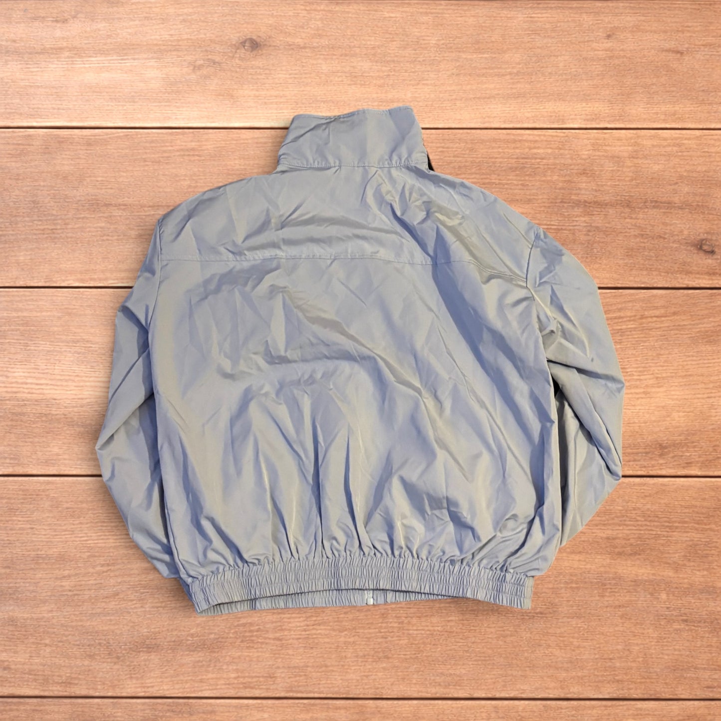 Light blue Japanese style zip up track jacket with black side stripes and toggle fasteners.
