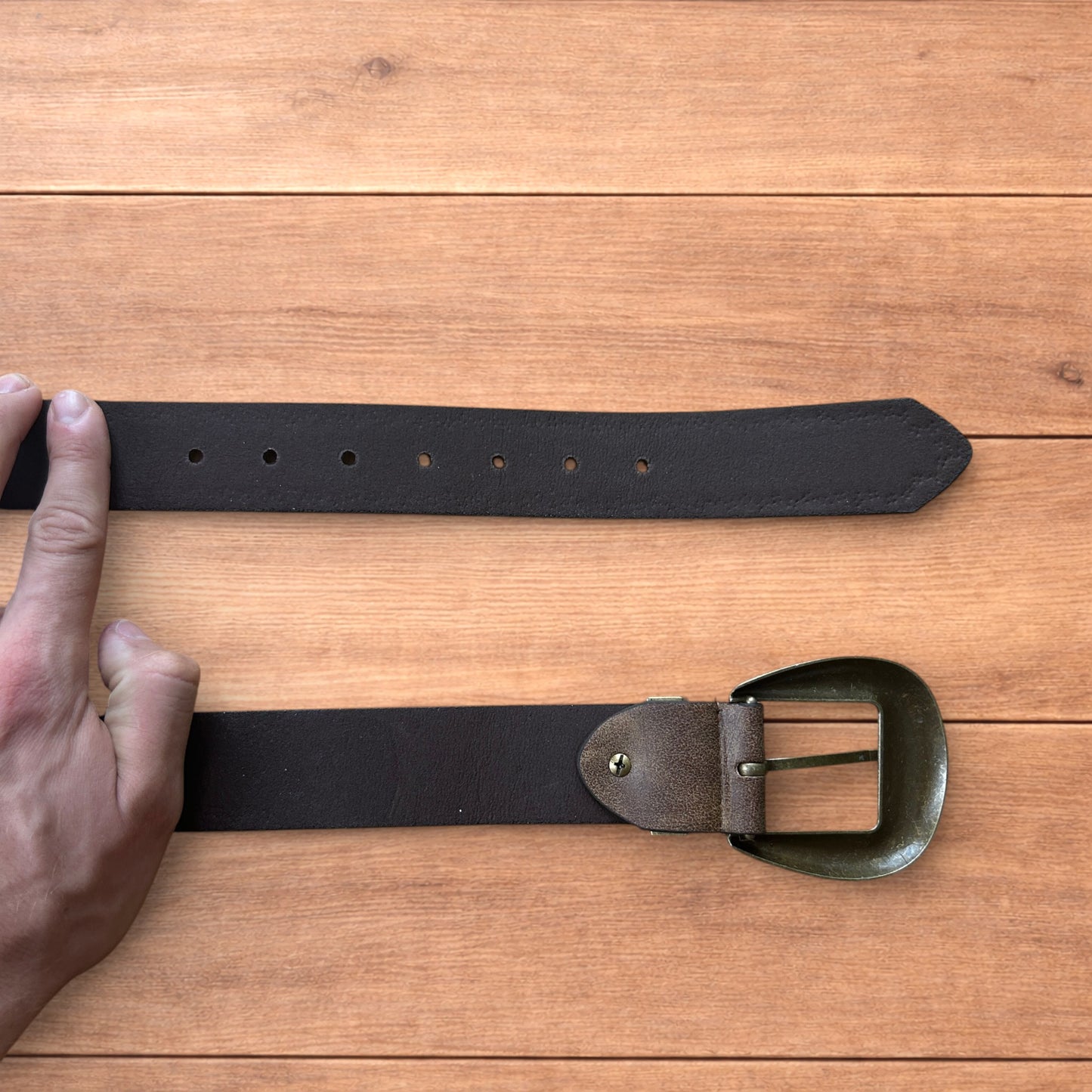 Vintage style faux leather western cowboy gothic belt in brown with brass trim.