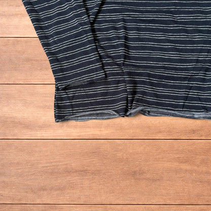 Relaxed fit navy and beige striped long sleeve top t-shirt laid flat on wooden surface showing front and back views.