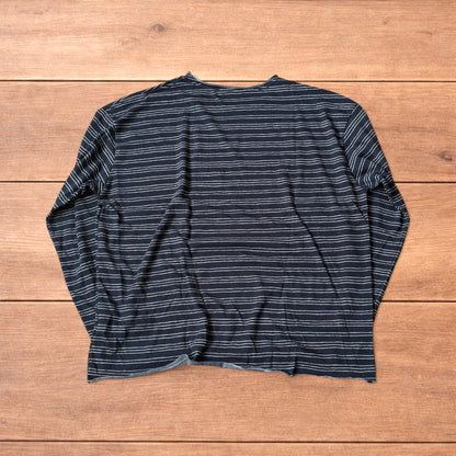 Relaxed fit navy and beige striped long sleeve top t-shirt laid flat on wooden surface showing front and back views.