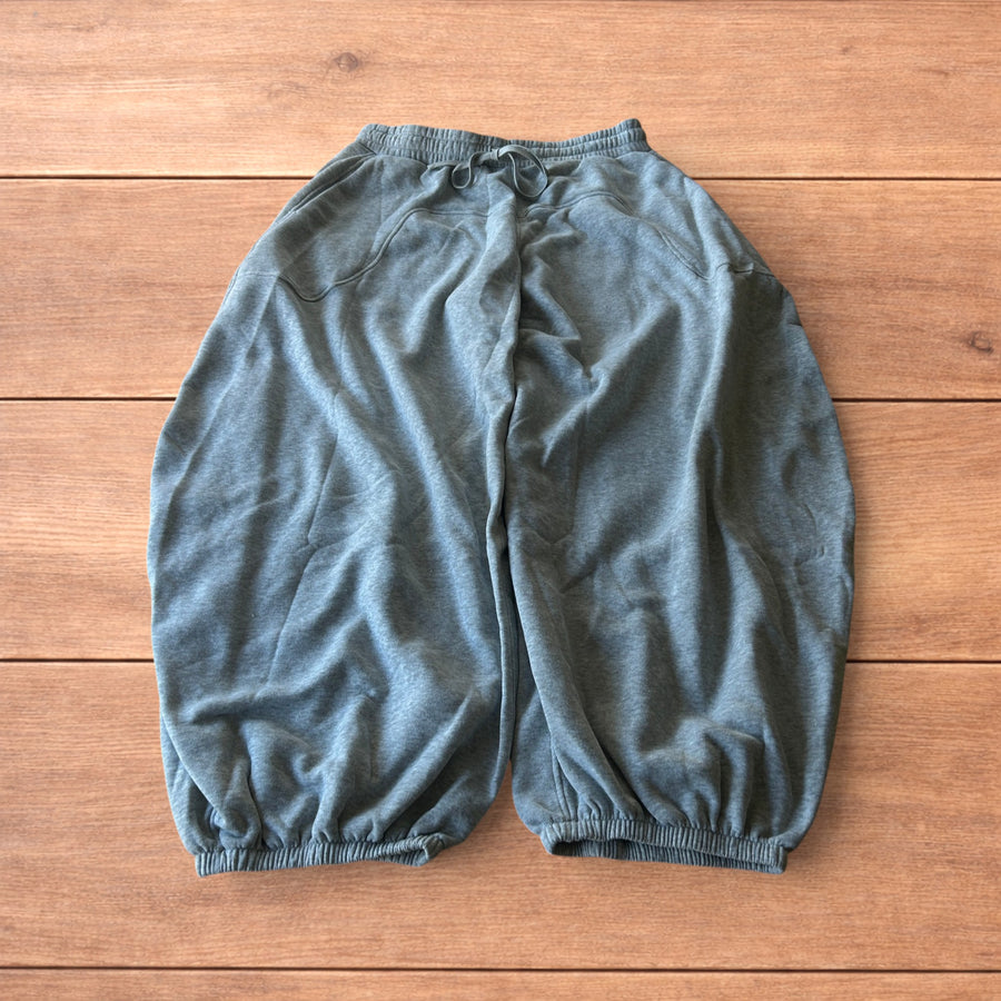 Super baggy wide leg Korean joggers in marl grey laid flat showing elasticated waistband, drawstring, pockets and wide cuffed legs