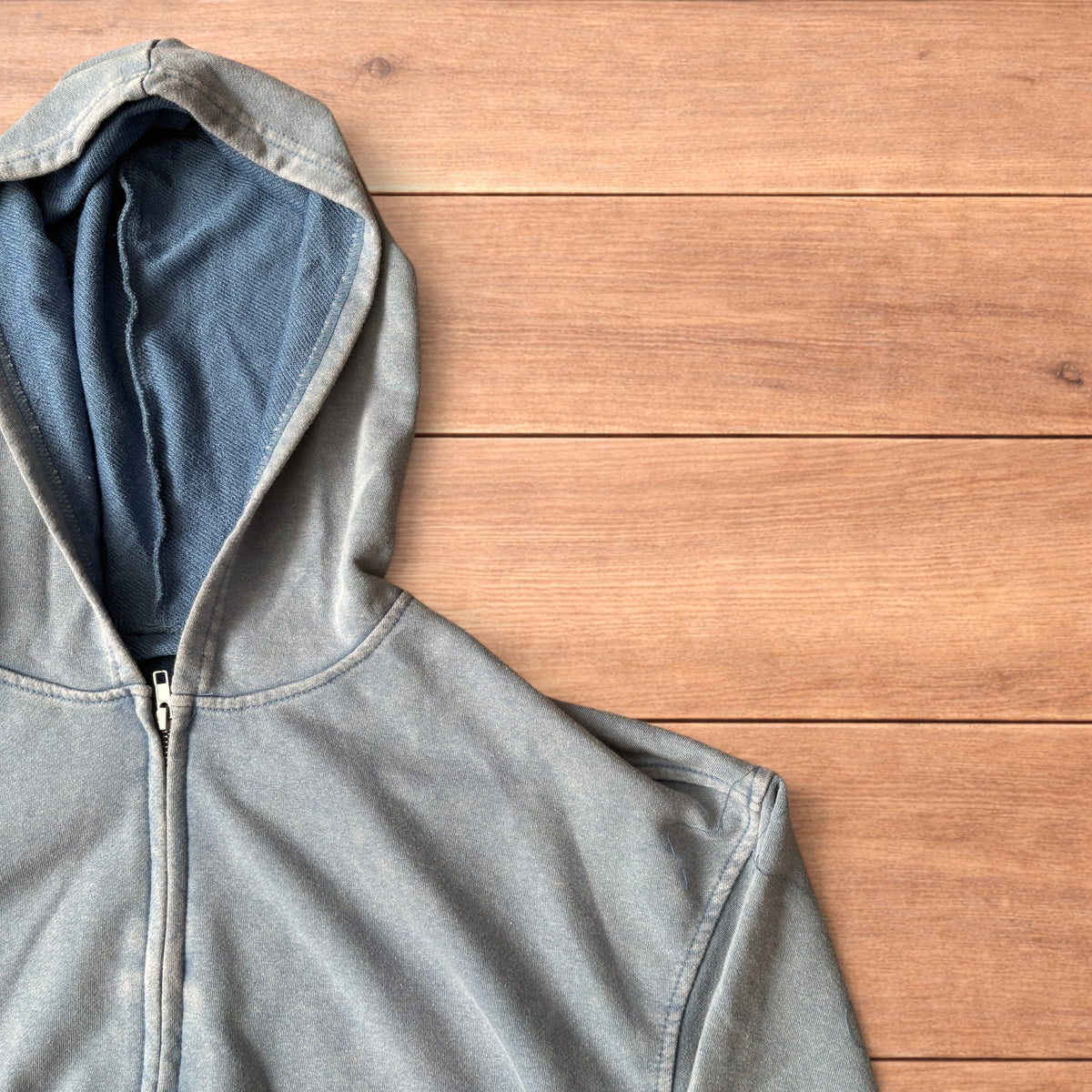 Light blue vintage style baggy zip up hoodie jumper laid flat showing front, back and details.