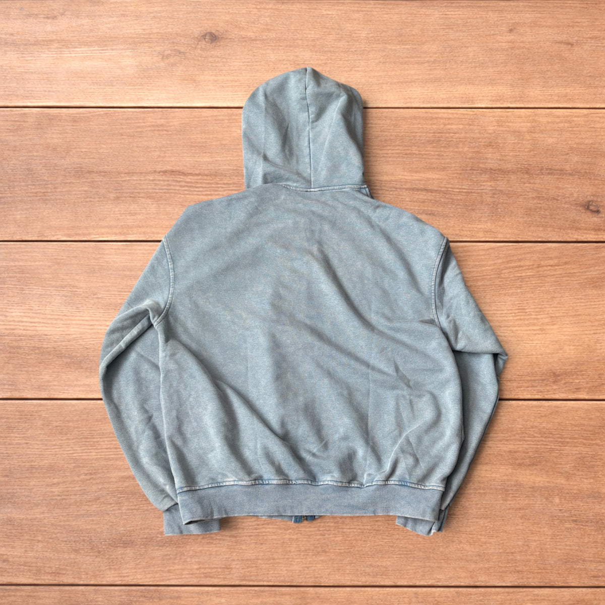 Light blue vintage style baggy zip up hoodie jumper laid flat showing front, back and details.